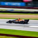 IndyCar speeding on track at Mid-Ohio Sports Car Course. Experience the thrill of motor racing.