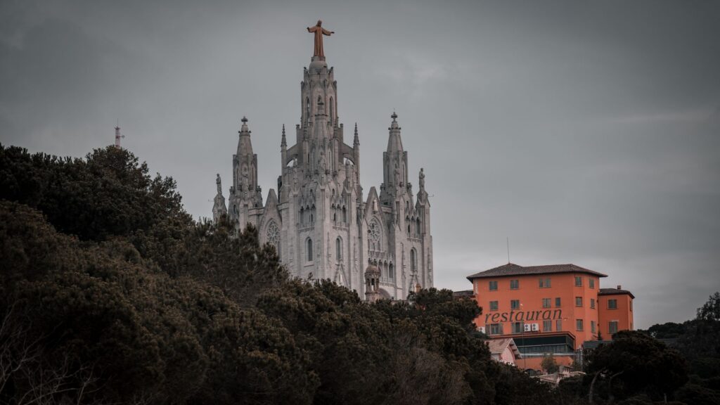 Discover the architectural splendor of Barcelona's iconic church amidst lush surroundings.