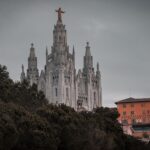 Discover the architectural splendor of Barcelona's iconic church amidst lush surroundings.