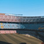 Wide shot of the iconic Camp Nou stadium in Barcelona, showcasing empty seats and football field.