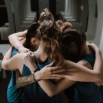 A group of athletes in a united huddle, symbolizing teamwork and unity in a sports changing room.