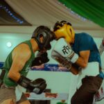 Two boxers engaged in a thrilling match wearing protective headgear and gloves.