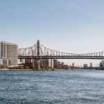 Famous cantilever Queensboro Bridge crossing East river placed in New York City under cloudless clue sky in daytime