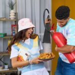 A fun moment indoors with friends enjoying snacks and a humorous twist using a fire extinguisher.