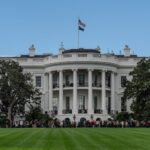 A picturesque view of the White House with the American flag in daylight.