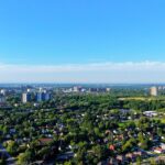 Aerial photograph showing a green urban residential area on a bright summer day.