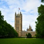 Stunning view of Victoria Tower with lush green surroundings in London, England, a historic and iconic landmark.