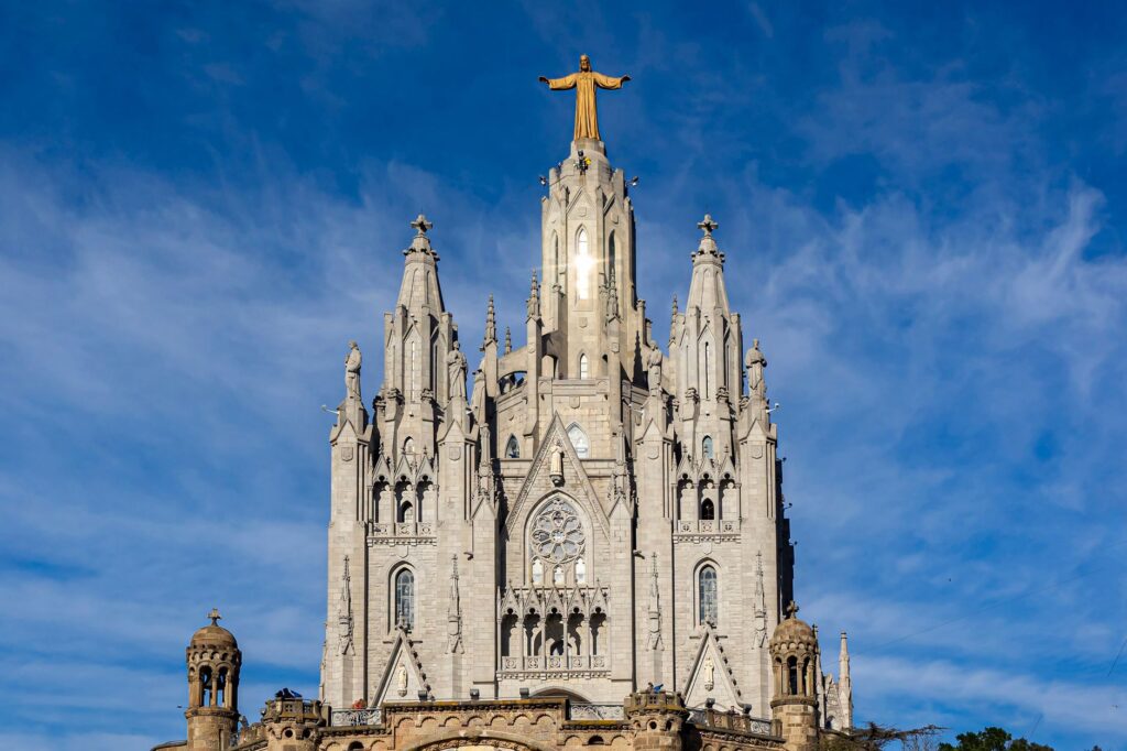A breathtaking view of the Temple of the Sacred Heart of Jesus under a vibrant blue sky in Barcelona.