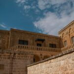Beautiful historic stone building in Midyat, showcasing intricate designs and clear skies.