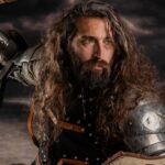 Bearded medieval warrior in armor and shield, poised for combat against a stormy backdrop.