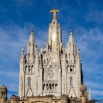 A breathtaking view of the Temple of the Sacred Heart of Jesus under a vibrant blue sky in Barcelona.