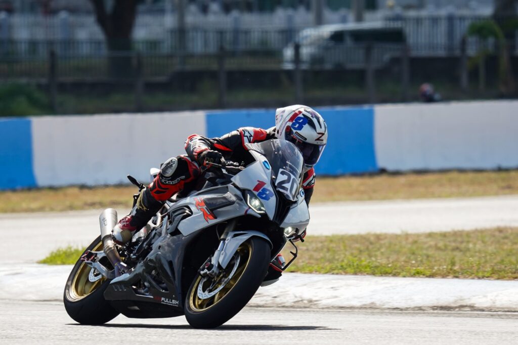 Professional motorcycle racer cornering on a track in Central Luzon, showcasing speed and skill.