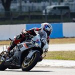 Professional motorcycle racer cornering on a track in Central Luzon, showcasing speed and skill.