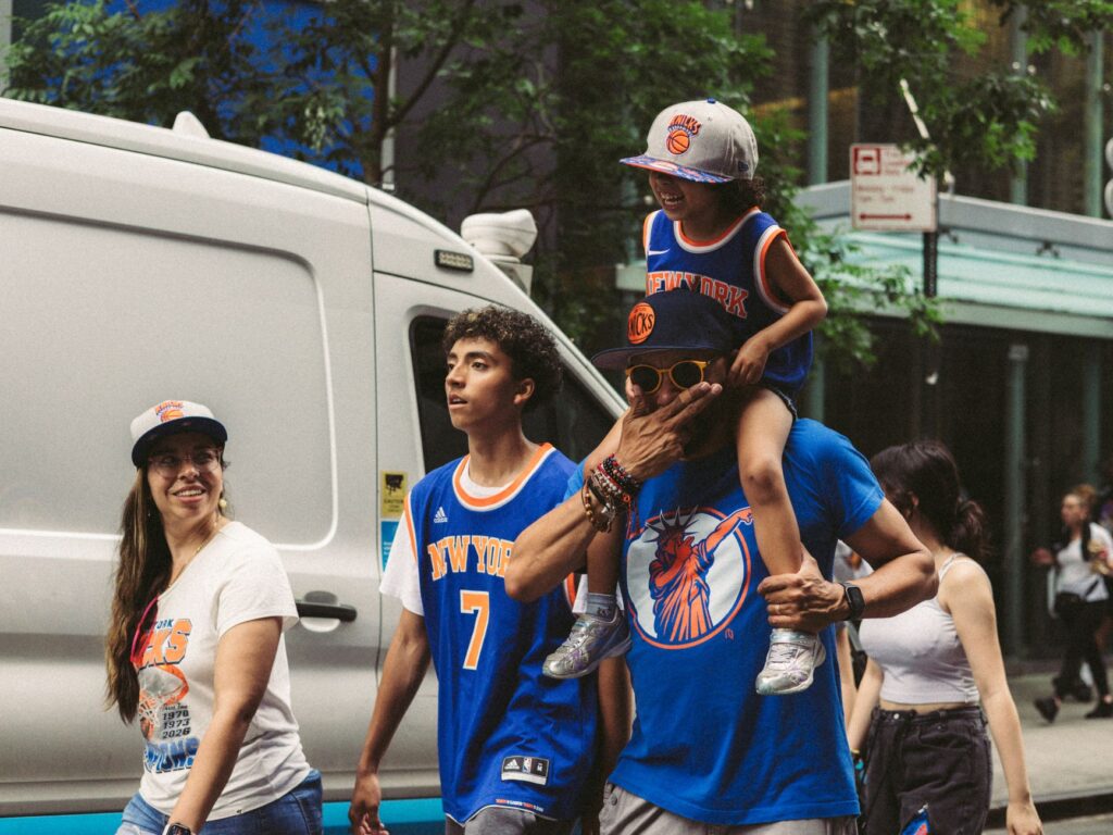 A group of sports fans in vibrant team apparel enjoying a lively day in the city.