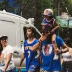 A group of sports fans in vibrant team apparel enjoying a lively day in the city.