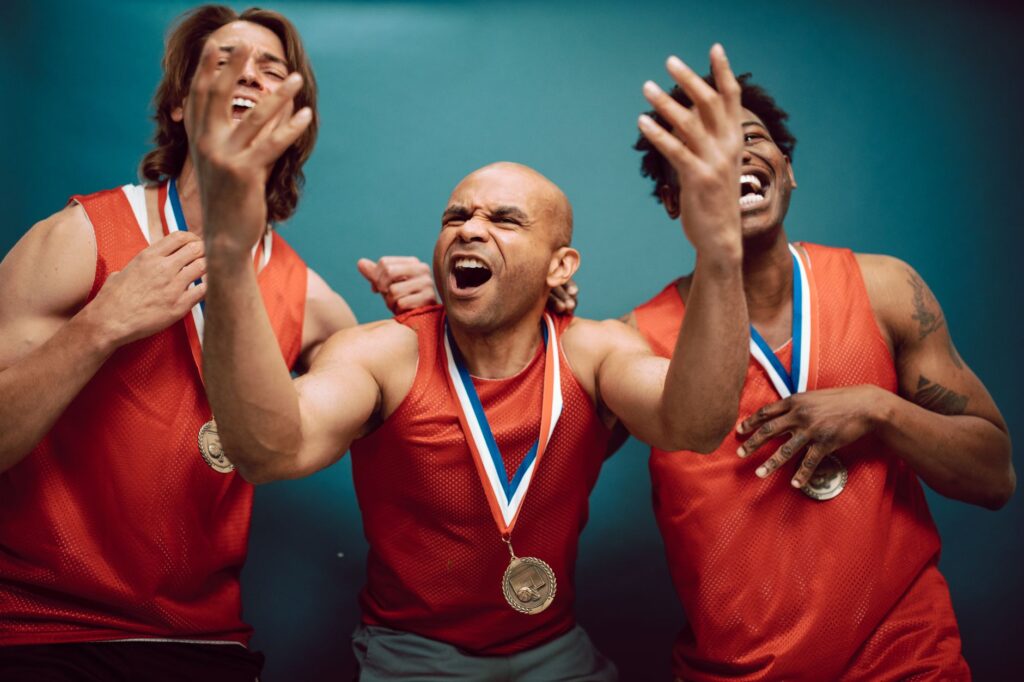 Three athletes celebrate their victory, showcasing joy and medals.