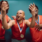 Three athletes celebrate their victory, showcasing joy and medals.