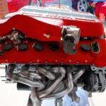 Powerful red engine on display indoors, showcasing intricate mechanics and engineering brilliance.