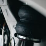 Detailed view of a vehicle's air suspension component with focus on texture and design.