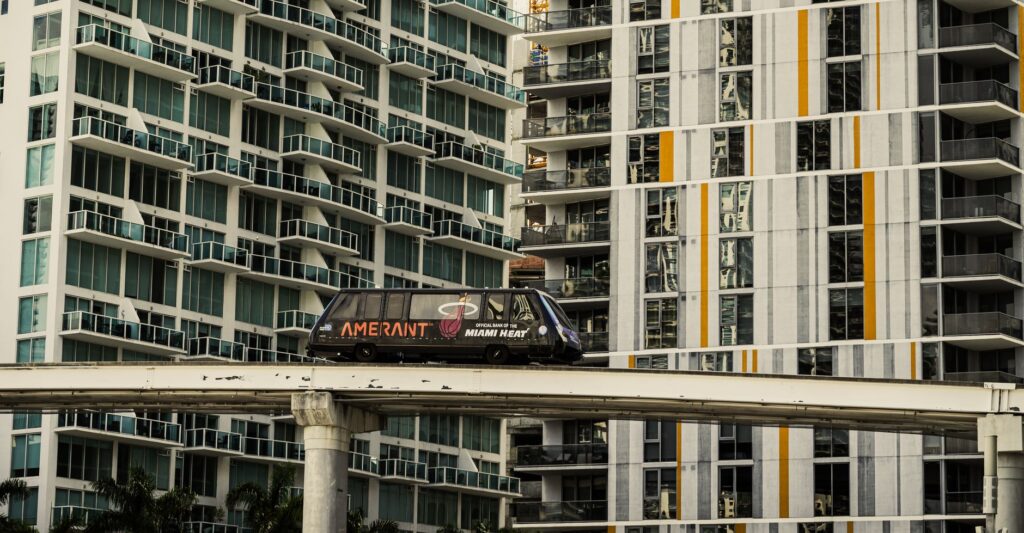 A Miami monorail travels past modern high-rise apartments in downtown Miami, Florida.