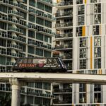 A Miami monorail travels past modern high-rise apartments in downtown Miami, Florida.