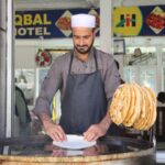 Local chef prepares traditional paratha at a food stall in Bahrain, Pakistan.