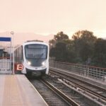 Modern train at Hilal Metro Station, Izmir, during sunset, showcasing public transportation.