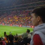 Crowd at a thrilling soccer match in Istanbul stadium with vibrant atmosphere.