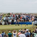 Golfers and fans gather for a thrilling tournament at Kiawah Island's lush course.