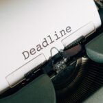 Close-up of a vintage typewriter with the word 'Deadline' on paper.