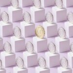 A gold medal stands out among silver medals on white cubes, showcasing uniqueness.
