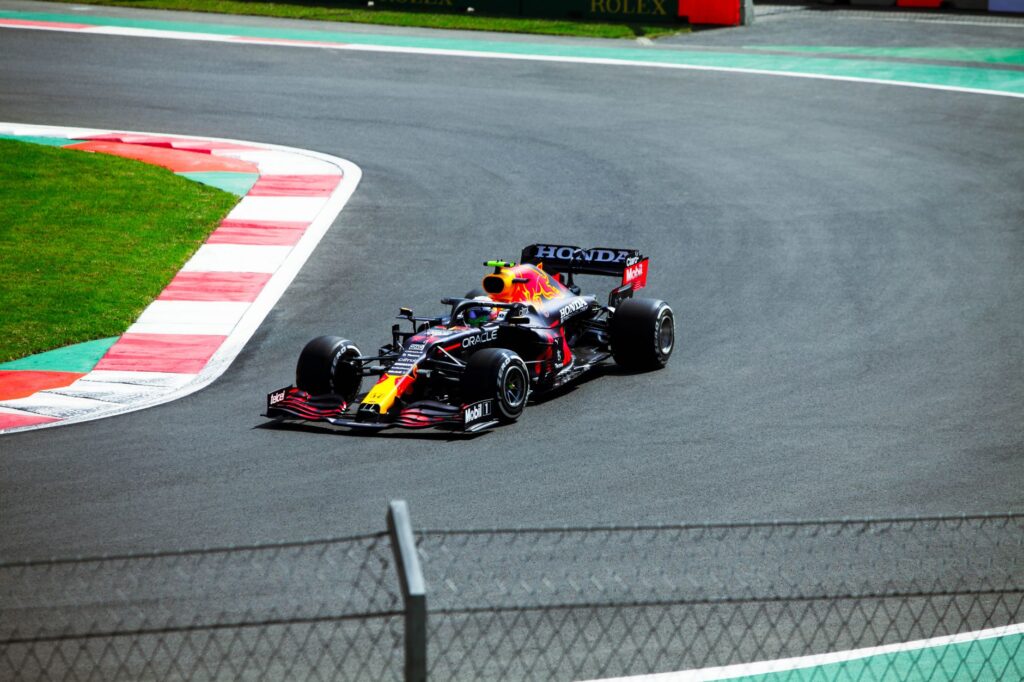 High-speed Formula One car racing at a circuit in Mexico City.