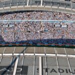 Aerial shot of Etihad Stadium filled with soccer fans in Manchester, UK.