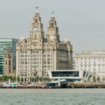 Scenic view of Liverpool's Royal Liver Building at the waterfront, showcasing architectural elegance.