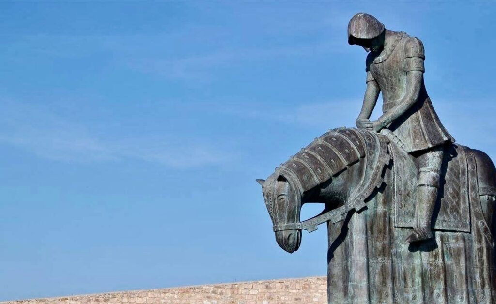 Imposing bronze statue of a knight on horseback, symbolizing historical strength and valor.