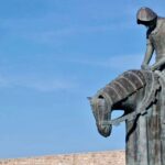 Imposing bronze statue of a knight on horseback, symbolizing historical strength and valor.