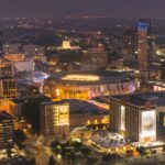 Dazzling aerial shot of downtown Sacramento showcasing the Golden 1 Center amid the vibrant cityscape at night.