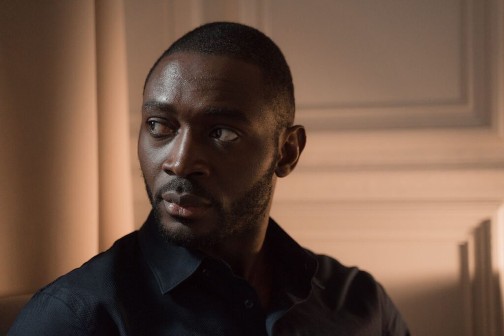 Close-up of a pensive man looking away indoors, capturing a serious expression.