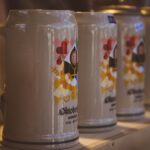 Close-up of colorful beer steins at Oktoberfest in Munich, Bavaria, highlighting festive designs.