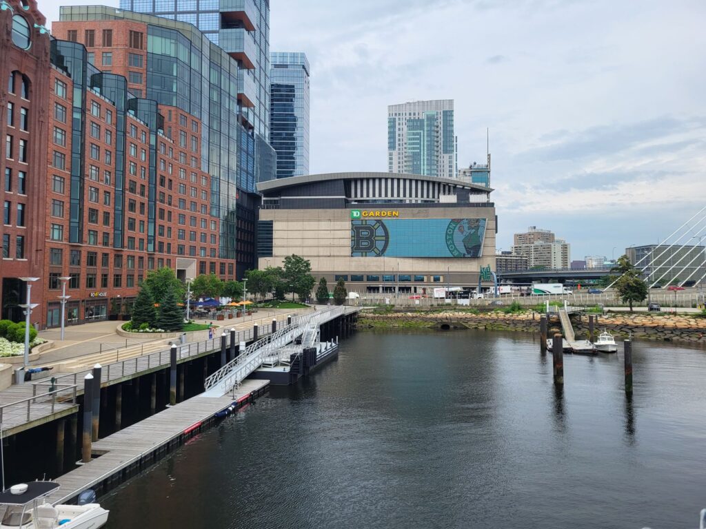 A picturesque view of TD Garden and the surrounding Boston harbor area with modern architecture.