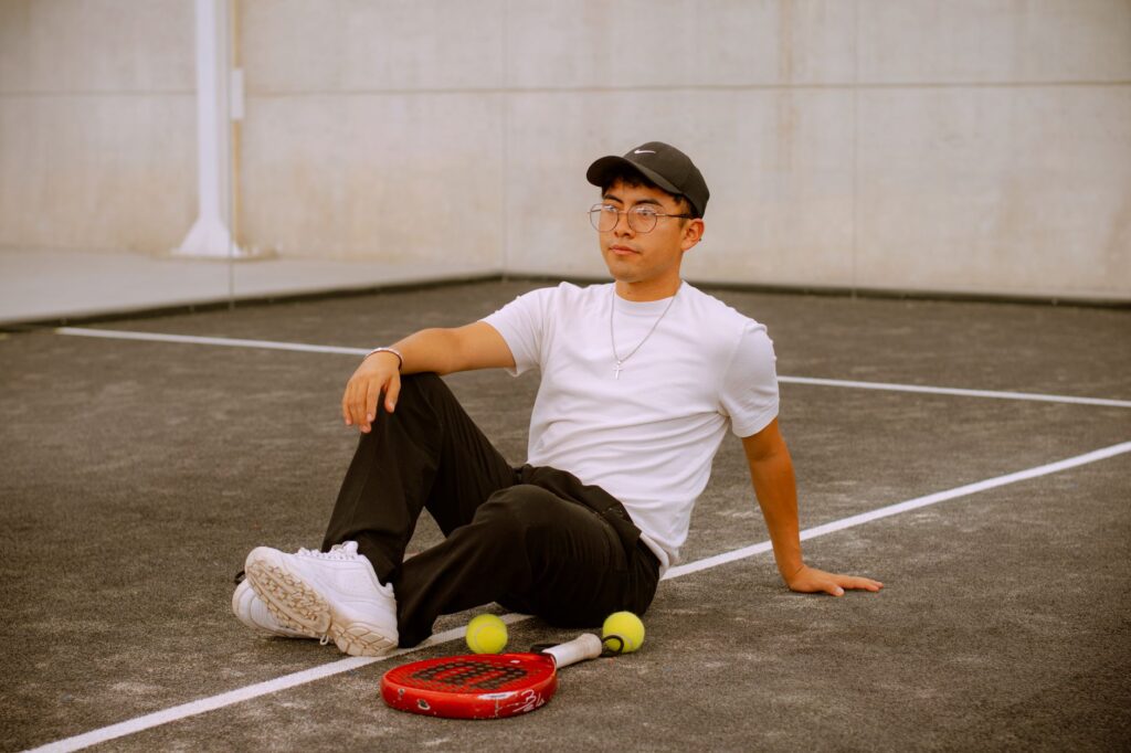 Young man relaxing on an outdoor padel court in Puebla, Mexico.