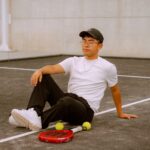 Young man relaxing on an outdoor padel court in Puebla, Mexico.