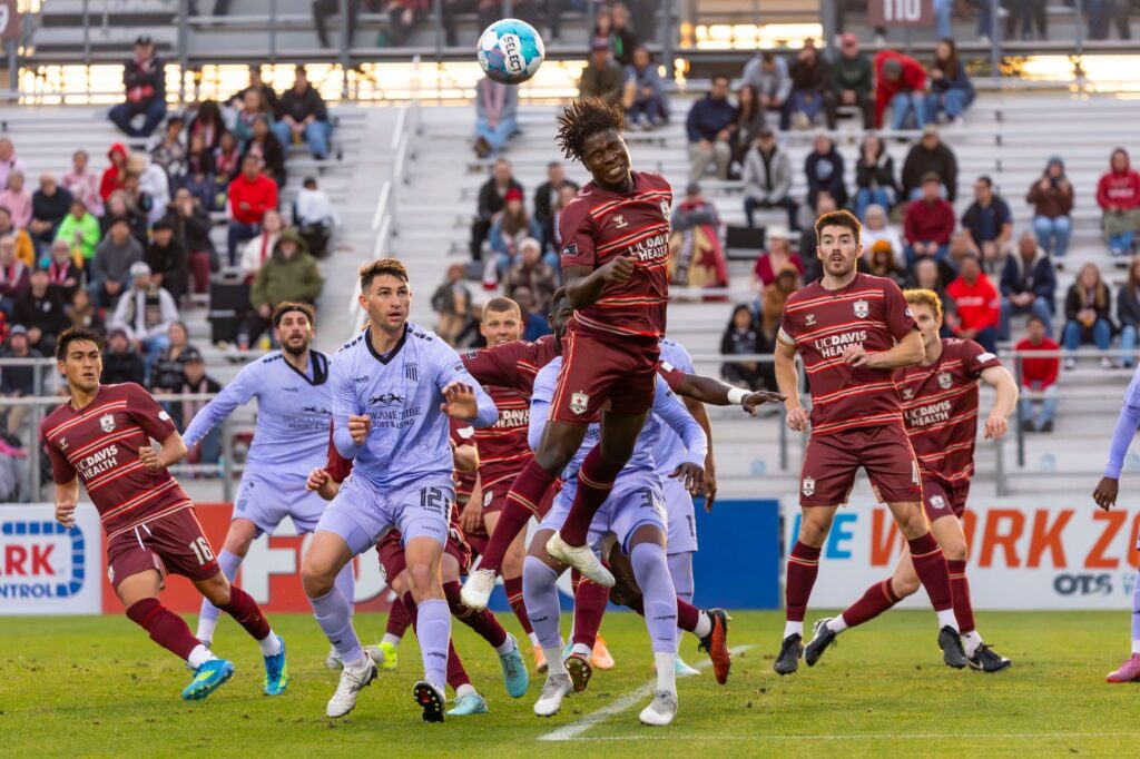 A thrilling moment captured during a competitive soccer match with players in action.