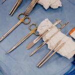 High angle view of surgical instruments on blue drapes, ready for use in the operating room.