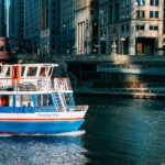 Tour boat cruising the Chicago River against a backdrop of urban architecture.