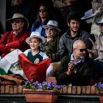 A diverse crowd enjoying a lively outdoor celebration in Montevideo, Uruguay.