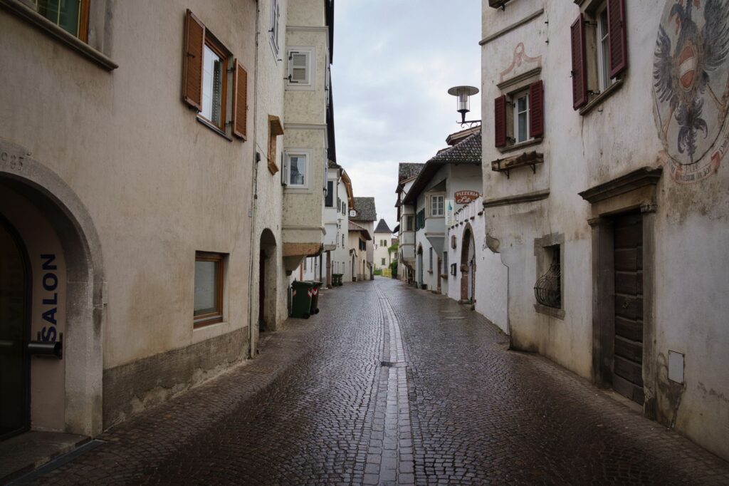 Quaint cobblestone street scene in Sankt Pauls, Trentino-Südtirol, Italy.