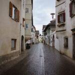 Quaint cobblestone street scene in Sankt Pauls, Trentino-Südtirol, Italy.