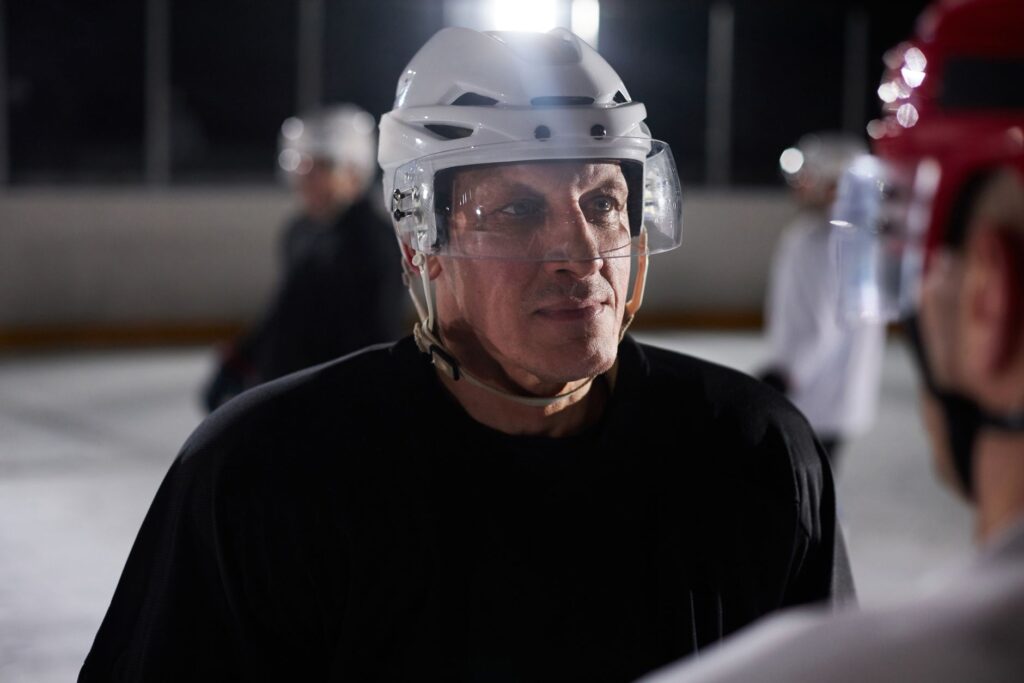 Close-up of an ice hockey player focused and serious during a practice session on the rink.