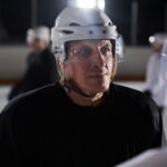 Close-up of an ice hockey player focused and serious during a practice session on the rink.